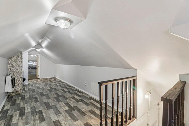 7659 S Rhodes Ave, Chicago, IL 60619 - additional living space with heating unit, vaulted ceiling, and dark wood-style flooring