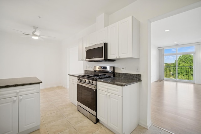 820 Weidner Rd Unit 405, Buffalo Grove, IL 60089 - kitchen featuring stainless steel appliances, ceiling fan, white cabinets, light tile patterned floors, and dark stone countertops