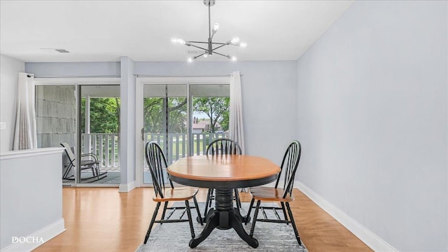 2051 Creekside Dr Unit 2-3, Wheaton, IL 60189 - dining room featuring a chandelier and light wood-type flooring