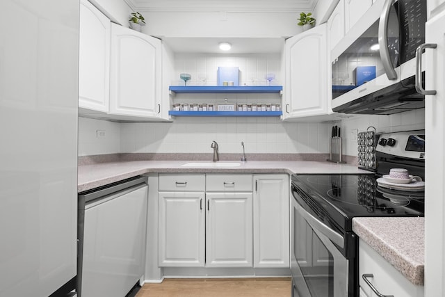 429 Wesley Ave Unit 301, Oak Park, IL 60302 - kitchen featuring appliances with stainless steel finishes, tasteful backsplash, white cabinetry, light countertops, and crown molding