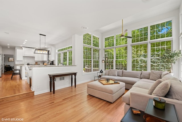 living area with light wood-style floors and recessed lighting