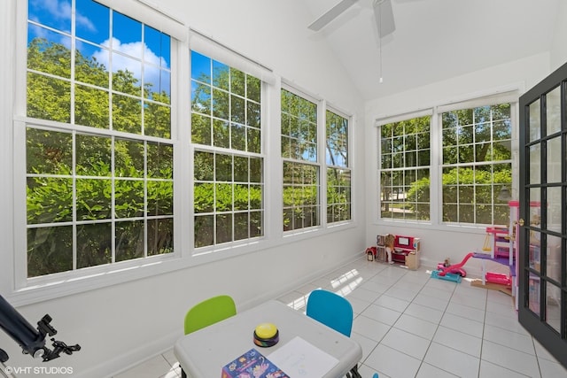 unfurnished sunroom featuring tile patterned flooring and vaulted ceiling