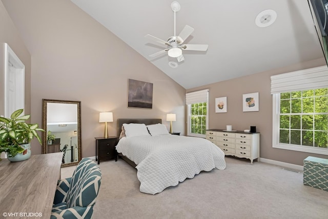 carpeted bedroom with high vaulted ceiling and a ceiling fan