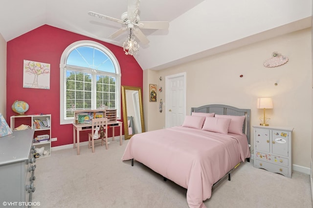bedroom with vaulted ceiling, light carpet, and a ceiling fan