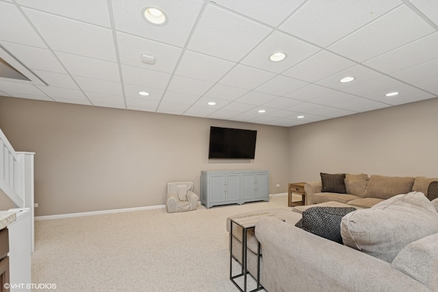 carpeted living room featuring recessed lighting and a drop ceiling