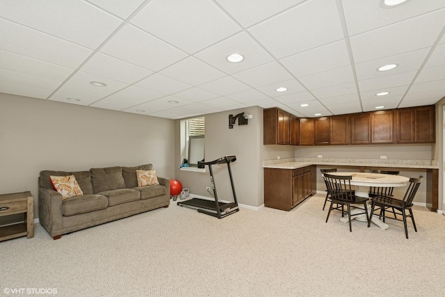 kitchen featuring light colored carpet, light countertops, recessed lighting, and open floor plan