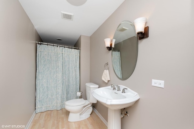 bathroom featuring wood finished floors and a shower with curtain