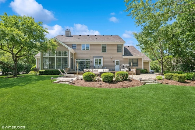 back of house featuring a patio, an outdoor living space, a chimney, and a yard