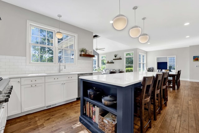 7270 Bannockburn Cir, Lakewood, IL 60014 - kitchen with open shelves, dishwashing machine, white cabinets, dark wood-style flooring, and a kitchen island