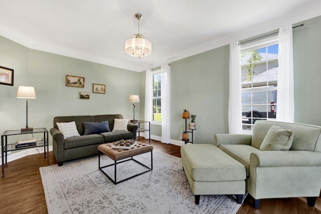 7270 Bannockburn Cir, Lakewood, IL 60014 - living room featuring healthy amount of natural light, dark wood-style flooring, a chandelier, and ornamental molding