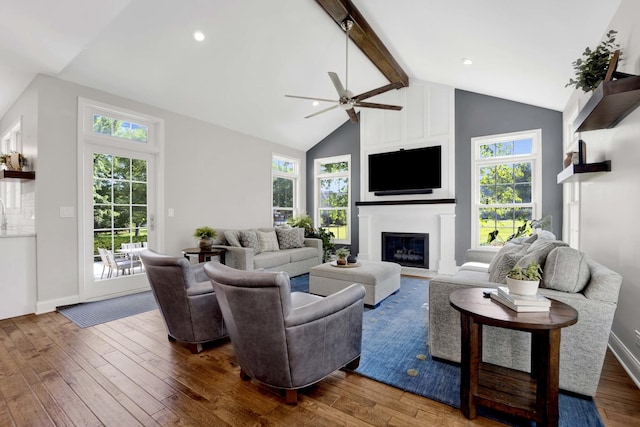 7270 Bannockburn Cir, Lakewood, IL 60014 - living room with wood-type flooring, ceiling fan, beam ceiling, a large fireplace, and plenty of natural light