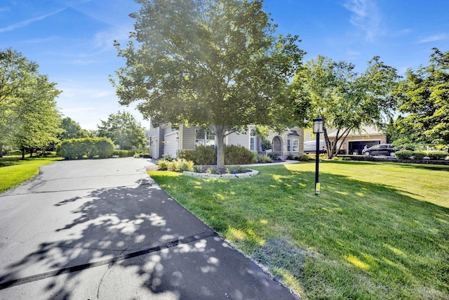 7270 Bannockburn Cir, Lakewood, IL 60014 - obstructed view of property with a front lawn and concrete driveway
