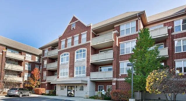 77 N Quentin Rd Unit 202, Palatine, IL 60067 - view of apartment building / complex featuring uncovered parking