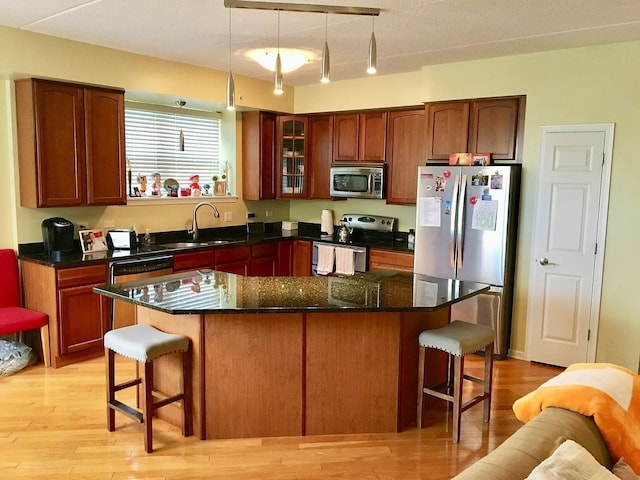 77 N Quentin Rd Unit 202, Palatine, IL 60067 - kitchen featuring appliances with stainless steel finishes, a kitchen breakfast bar, light wood-style floors, and pendant lighting