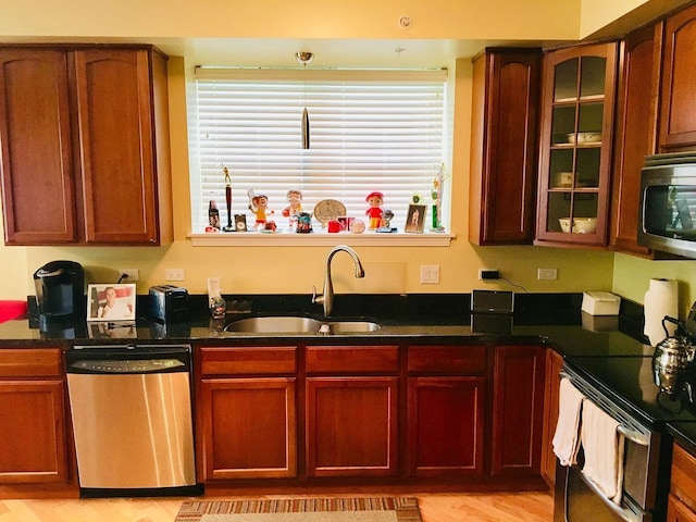 77 N Quentin Rd Unit 202, Palatine, IL 60067 - kitchen featuring stainless steel appliances, glass insert cabinets, light wood-style flooring, and dark stone counters