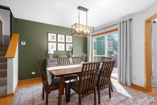 1809 Winmont Ct, Montgomery, IL 60538 - dining area with light wood-type flooring, a chandelier, and stairway