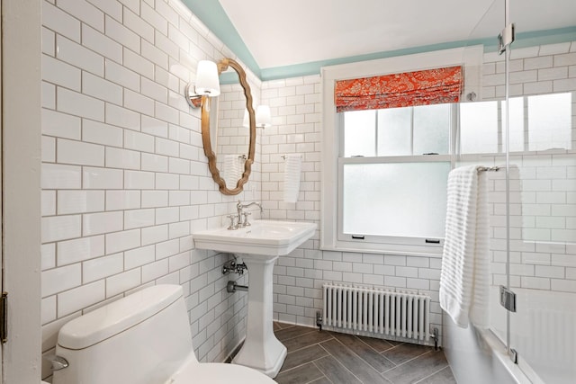 343 Washington Ave, Wilmette, IL 60091 - bathroom featuring radiator, tile walls, enclosed tub / shower combo, and lofted ceiling
