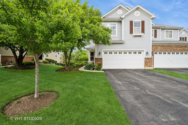 646 Grand Canyon Cir, Crystal Lake, IL 60014 - view of front facade featuring driveway, a garage, brick siding, and a front yard