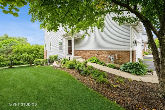646 Grand Canyon Cir, Crystal Lake, IL 60014 - view of front of property featuring a front yard, a garage, and brick siding