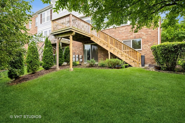 646 Grand Canyon Cir, Crystal Lake, IL 60014 - back of house with stairway, a lawn, a wooden deck, and brick siding