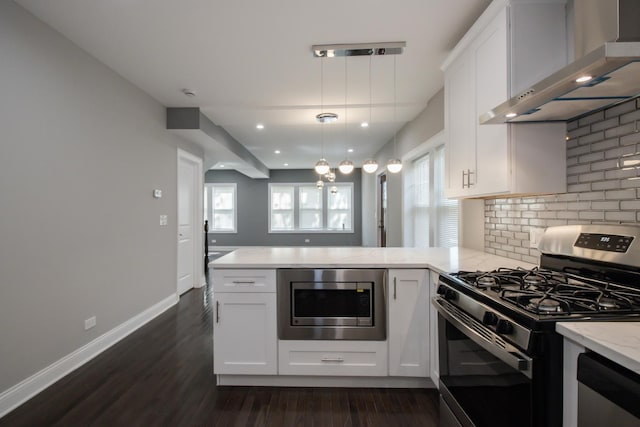 8930 S Throop St, Chicago, IL 60620 - kitchen featuring stainless steel appliances, wall chimney exhaust hood, a peninsula, dark wood finished floors, and light stone counters