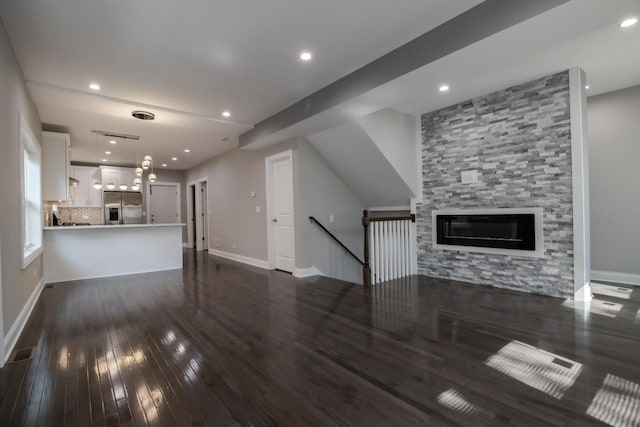 8930 S Throop St, Chicago, IL 60620 - unfurnished living room with dark wood finished floors, recessed lighting, and a large fireplace