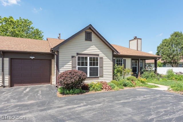 1827 Appaloosa Dr, Naperville, IL 60565 - ranch-style house with an attached garage, a chimney, asphalt driveway, and roof with shingles