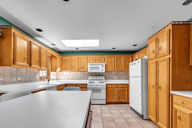 11254 S Whipple St, Chicago, IL 60655 - kitchen with white appliances, a skylight, light countertops, and tasteful backsplash