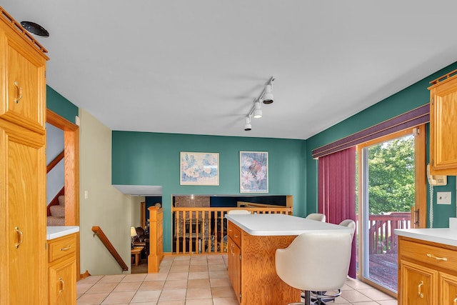 11254 S Whipple St, Chicago, IL 60655 - kitchen with light tile patterned floors, light countertops, a center island, and rail lighting