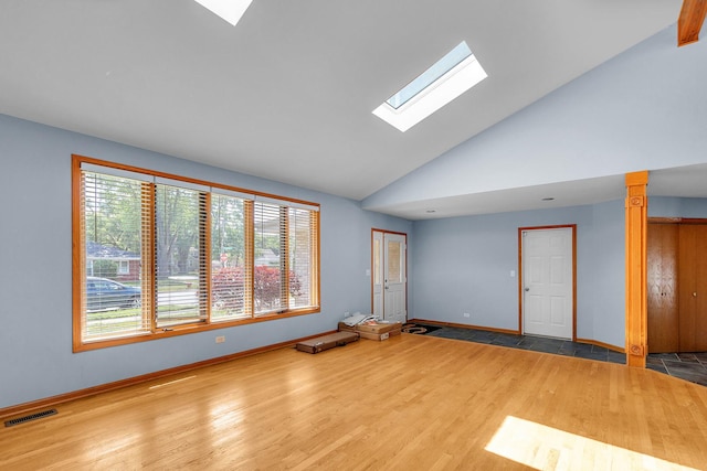 11254 S Whipple St, Chicago, IL 60655 - unfurnished room featuring a skylight, plenty of natural light, wood finished floors, and lofted ceiling