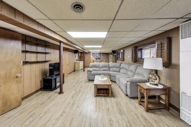 5836 S Menard Ave, Chicago, IL 60638 - living room featuring light wood-style floors, a heating unit, and a paneled ceiling