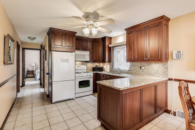 5836 S Menard Ave, Chicago, IL 60638 - kitchen featuring white appliances, a peninsula, ceiling fan, and decorative backsplash