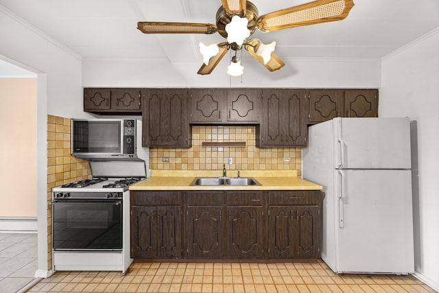 1139 Leavitt Ave Unit 313, Flossmoor, IL 60422 - kitchen featuring freestanding refrigerator, range with gas cooktop, dark brown cabinetry, light countertops, and crown molding