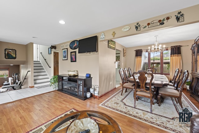 8825 Abbey Ln, Orland Park, IL 60462 - dining room with a chandelier, wood finished floors, stairs, and recessed lighting