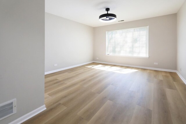 1653 Geneva Dr, Wheeling, IL 60090 - empty room featuring baseboards and light wood-type flooring