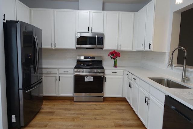 1653 Geneva Dr, Wheeling, IL 60090 - kitchen with stainless steel appliances, light countertops, and white cabinetry
