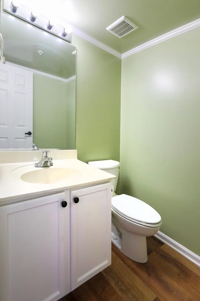 1653 Geneva Dr, Wheeling, IL 60090 - half bathroom with vanity, wood finished floors, and ornamental molding