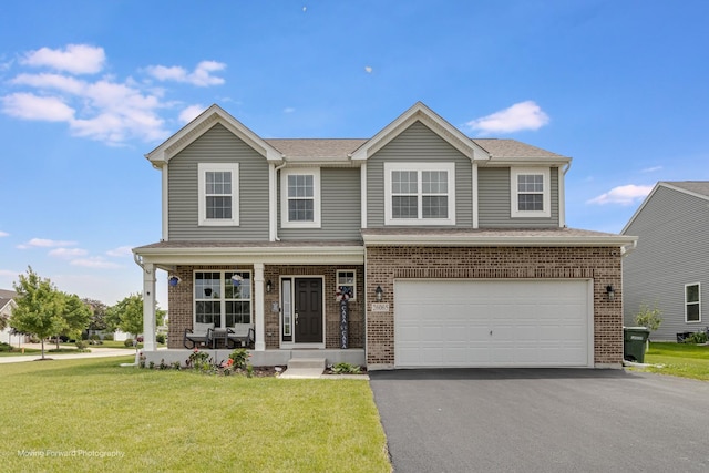 26065 S White Oak Trl, Channahon, IL 60410 - view of front facade with driveway, a porch, a front yard, and brick siding