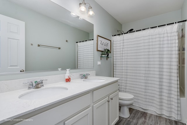 26065 S White Oak Trl, Channahon, IL 60410 - bathroom with double vanity, wood finished floors, and shower / tub combo with curtain