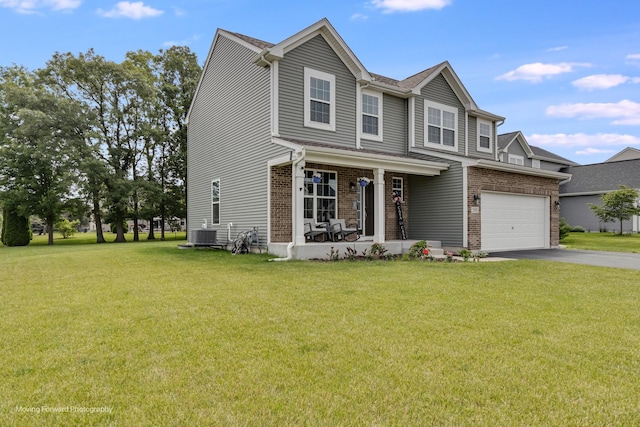 26065 S White Oak Trl, Channahon, IL 60410 - view of front facade featuring driveway, brick siding, a front yard, covered porch, and an attached garage