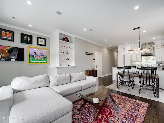 1841 N Sheffield Ave Unit 2, Chicago, IL 60614 - living room featuring ornamental molding, dark wood-style flooring, recessed lighting, and a chandelier