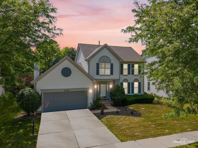 1348 Amaranth Dr, Naperville, IL 60564 - view of front of home with an attached garage, a front yard, and driveway