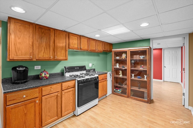 1348 Amaranth Dr, Naperville, IL 60564 - kitchen featuring black gas range, light wood-style flooring, dark countertops, recessed lighting, and brown cabinetry