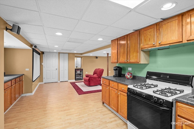 1348 Amaranth Dr, Naperville, IL 60564 - kitchen with gas range oven, light wood-type flooring, dark countertops, brown cabinets, and recessed lighting