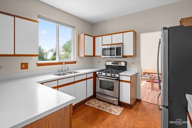 1348 Amaranth Dr, Naperville, IL 60564 - kitchen with stainless steel appliances, wood finished floors, white cabinets, and light countertops