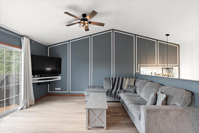 2447 Saddle Ridge Dr, Joliet, IL 60432 - living room featuring a decorative wall, a ceiling fan, light wood finished floors, and vaulted ceiling