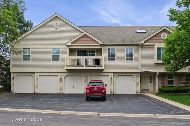 1257 Ballantrae Pl Unit C, Mundelein, IL 60060 - view of property with an attached garage, driveway, a balcony, and roof with shingles