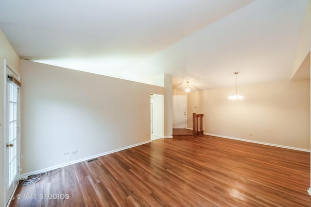 1257 Ballantrae Pl Unit C, Mundelein, IL 60060 - spare room with wood finished floors, a chandelier, and lofted ceiling