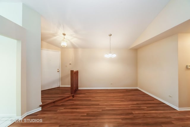 1257 Ballantrae Pl Unit C, Mundelein, IL 60060 - unfurnished room with vaulted ceiling, wood finished floors, and a chandelier