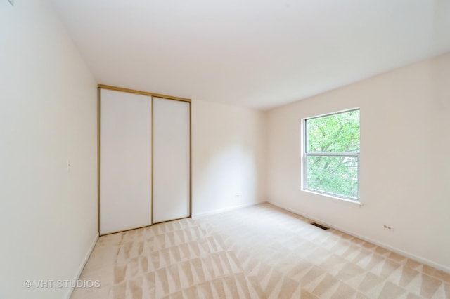 1257 Ballantrae Pl Unit C, Mundelein, IL 60060 - unfurnished bedroom with light colored carpet and a closet
